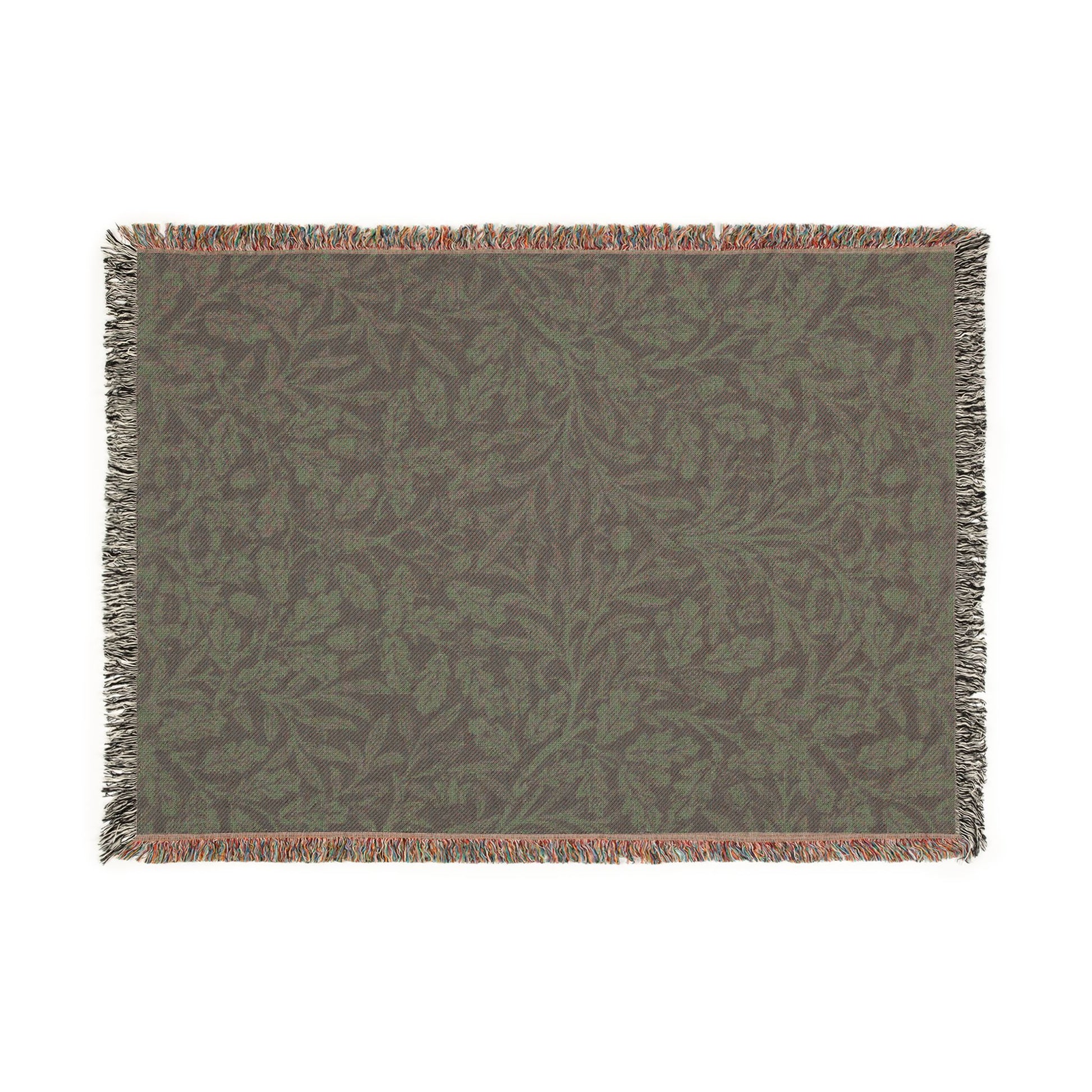 Green patterned throw blanket with fringe on a white background