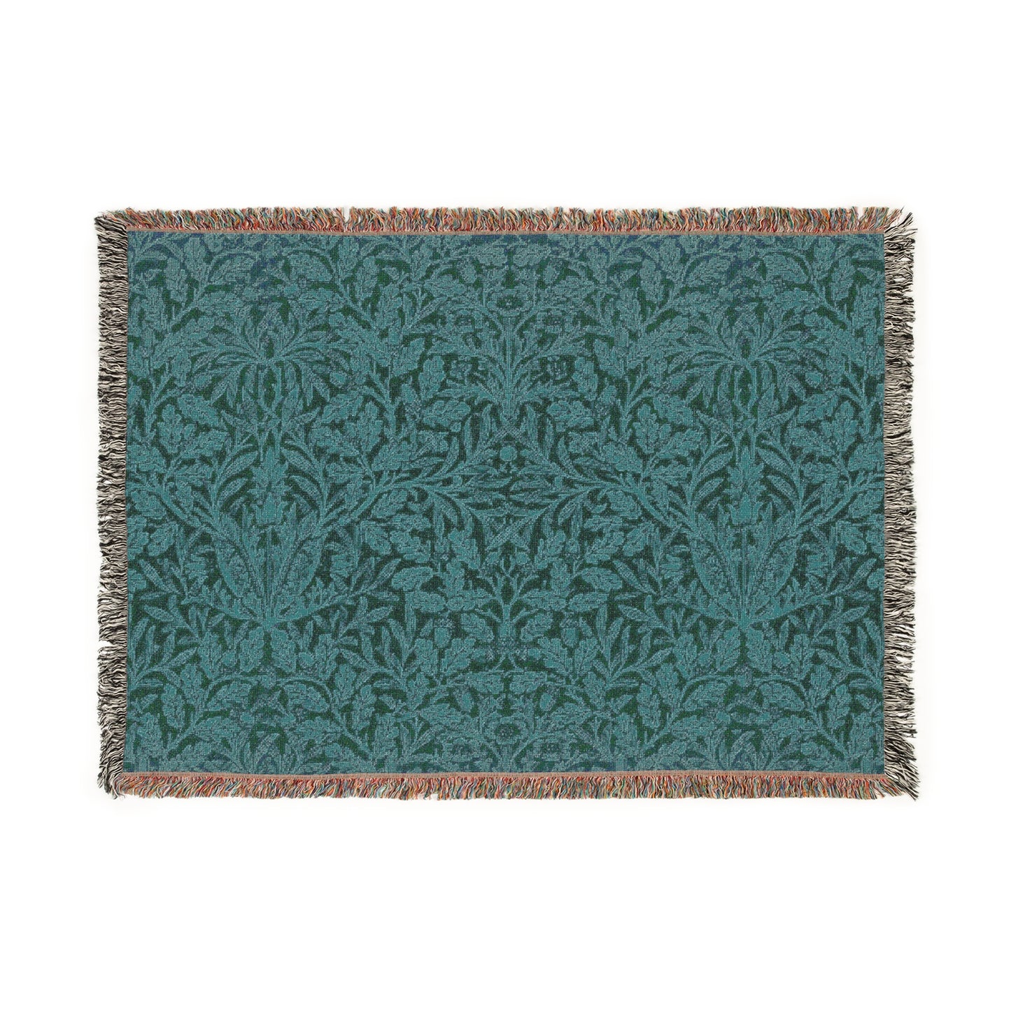 A woven cotton blanket with a William Morris & Co floral geometric pattern in teal colour, featuring a fringe.