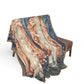 Decorative throw blanket with intricate patterns draped over a chair on a white background