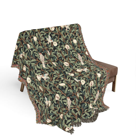 Patterned blanket draped over a chair on a white background
