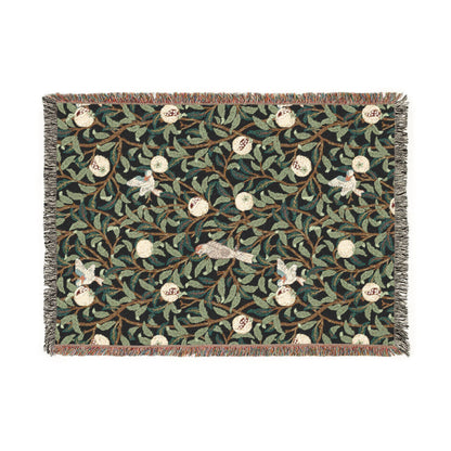 Decorative woven blanket with floral and bird pattern on a white background