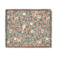 A woven cotton blanket with a floral pattern in shades of green and beige, featuring birds and pomegranate motifs, with a colorful fringed edge.