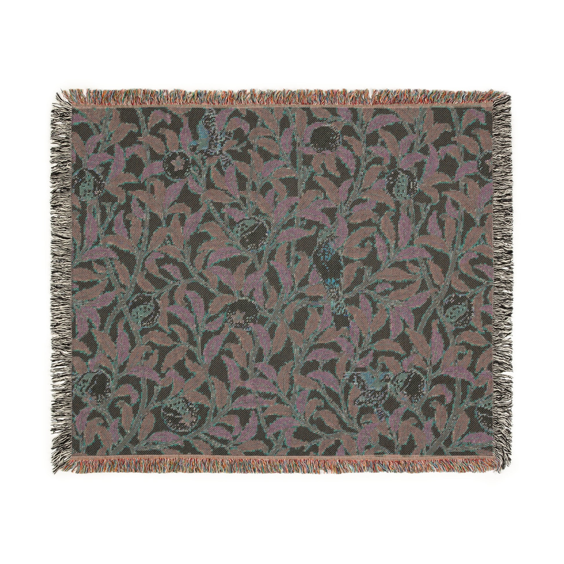 A woven cotton blanket with a floral William Morris & Co pattern in shades of green and beige, featuring birds and pomegranate motifs, with a colourful fringed edge.