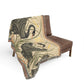 Decorative throw blanket with swan design draped over a brown chair on a white background