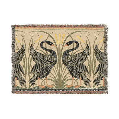 Woven blanket with black swan design on a beige background