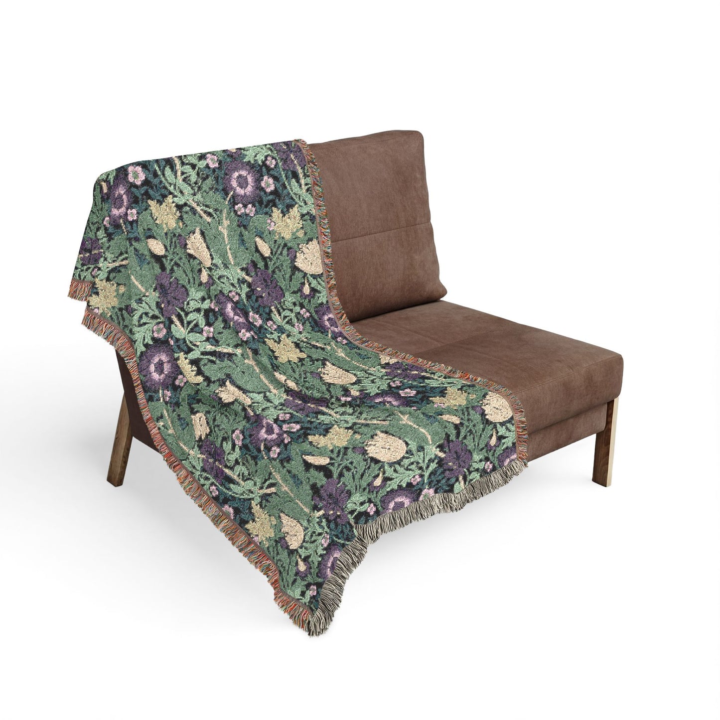 Floral patterned throw blanket draped over a brown chair on a white background