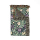 Floral patterned blanket with fringes on a white background