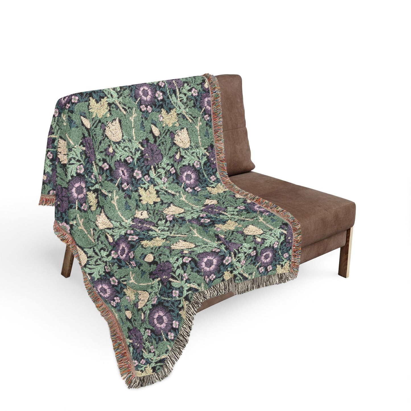 Floral patterned blanket draped over a brown chair on a white background