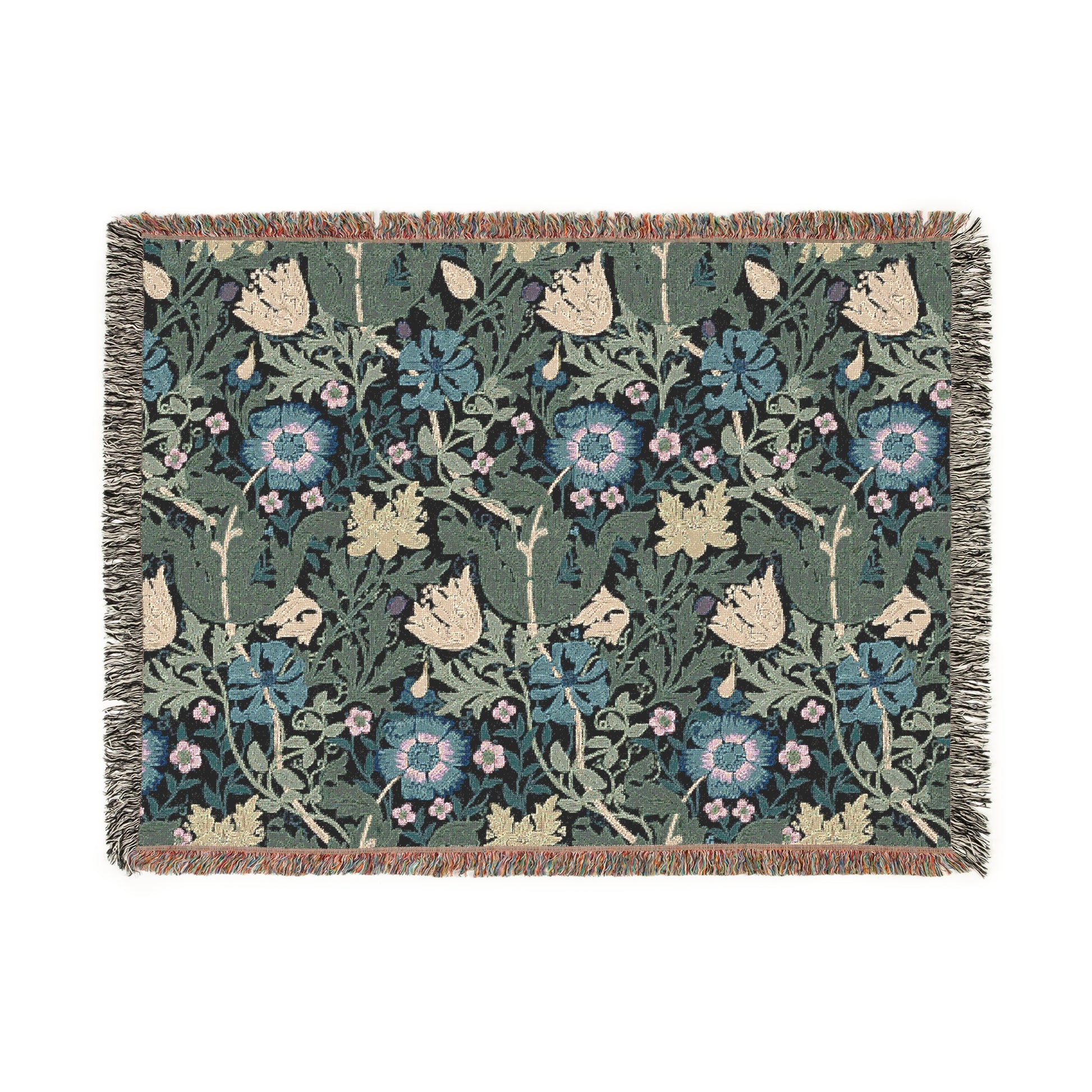 A woven cotton blanket with a floral pattern in blue, green, and beige colors, featuring fringed edges.