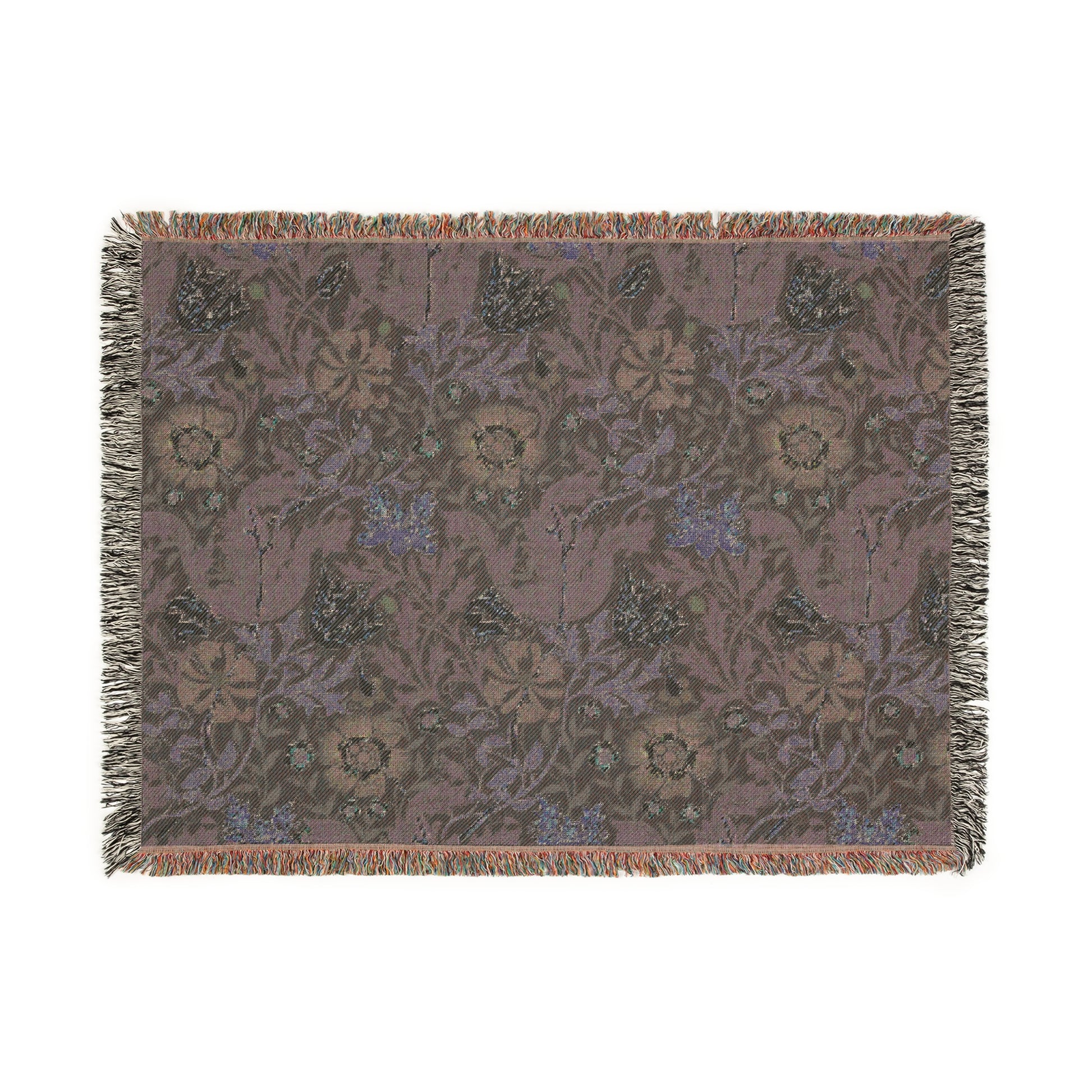 A woven cotton blanket with a floral William Morris & Co pattern in blue, green, and beige colours, featuring fringed edges.
