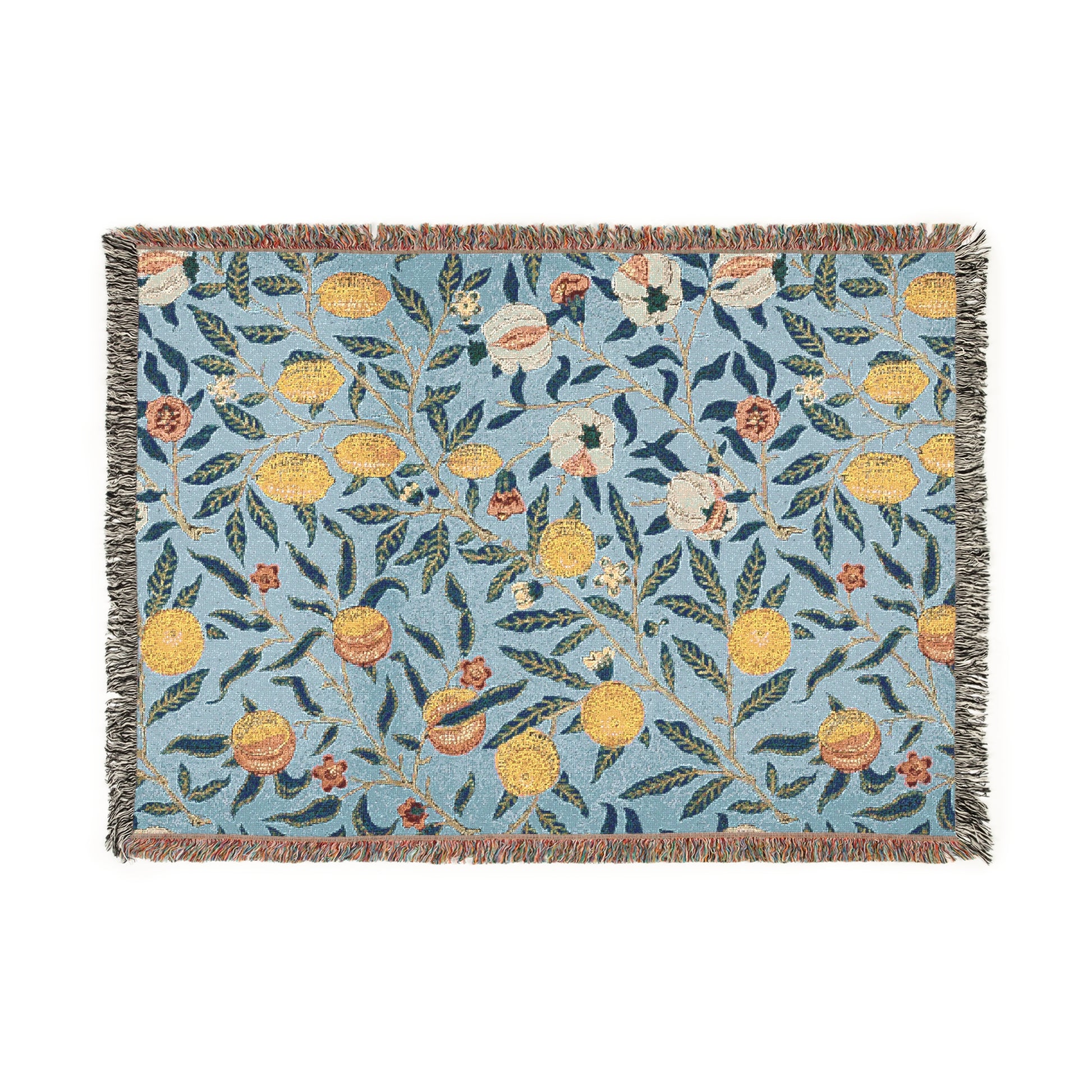 A woven cotton blanket with a floral William Morris & Co pattern in shades of blue and yellow, featuring colourful fruit motifs and a fringed edge.