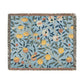 A woven cotton blanket with a floral pattern in shades of blue and yellow, featuring colorful fruit motifs and a fringed edge.