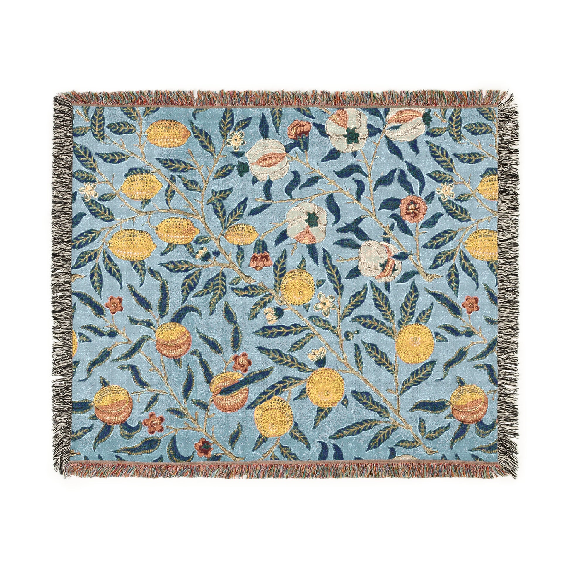 A woven cotton blanket with a floral pattern in shades of blue and yellow, featuring colorful fruit motifs and a fringed edge.