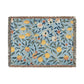 A woven cotton blanket with a floral pattern in shades of blue and yellow, featuring colorful fruit motifs and a fringed edge.
