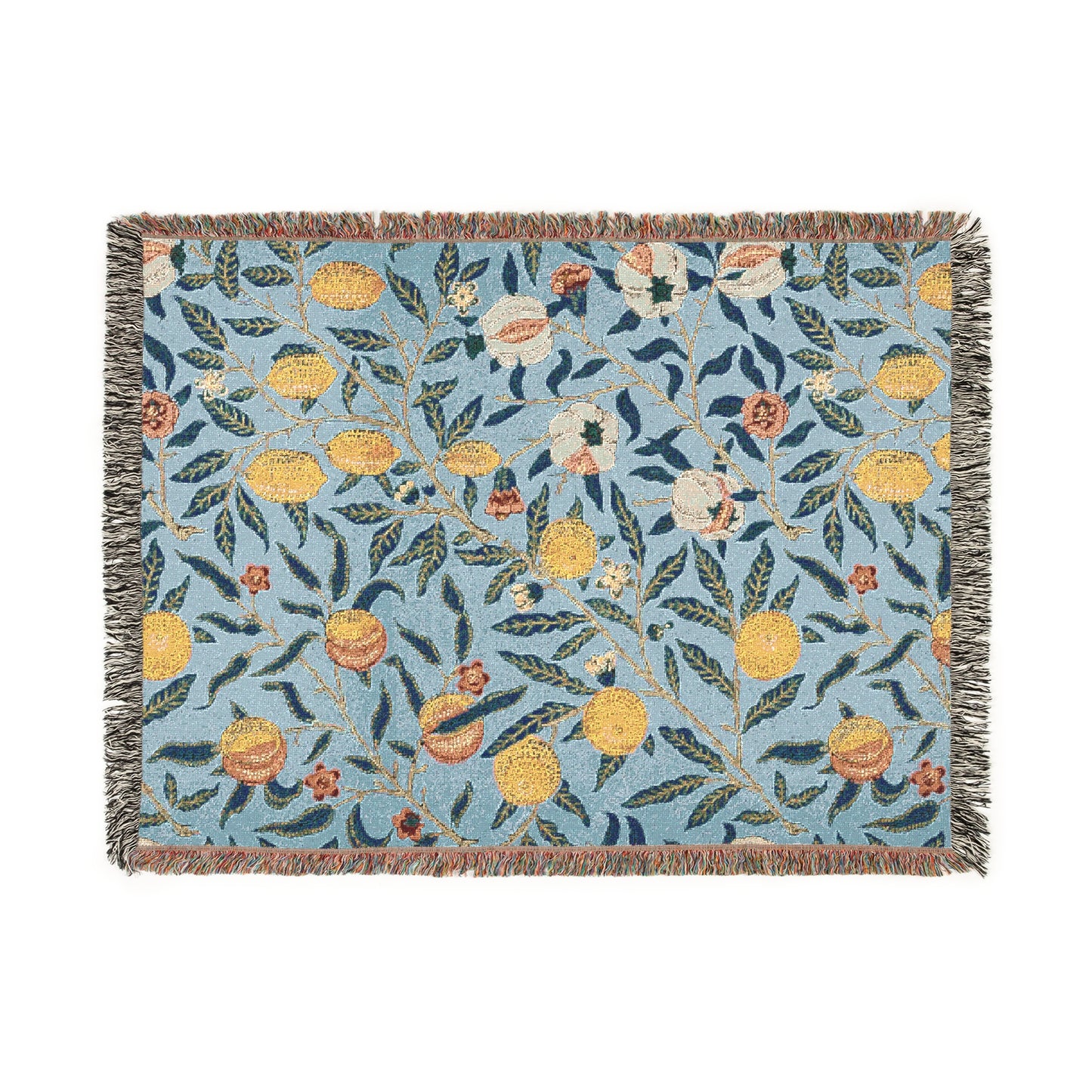 A woven cotton blanket with a floral pattern in shades of blue and yellow, featuring colorful fruit motifs and a fringed edge.