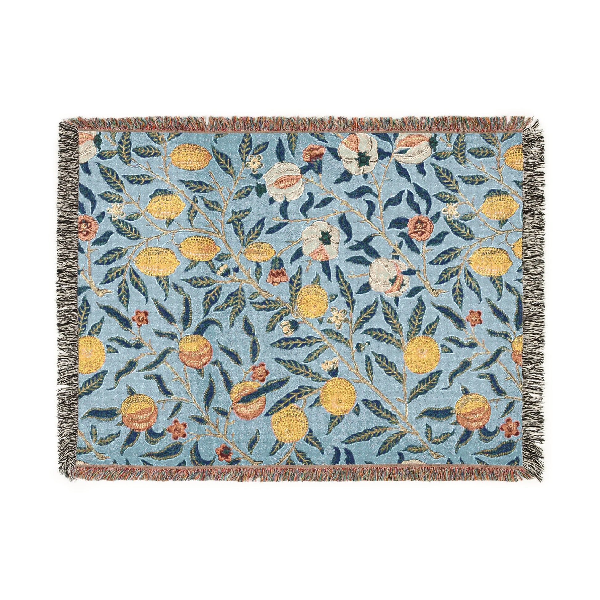 A woven cotton blanket with a floral pattern in shades of blue and yellow, featuring colorful fruit motifs and a fringed edge.