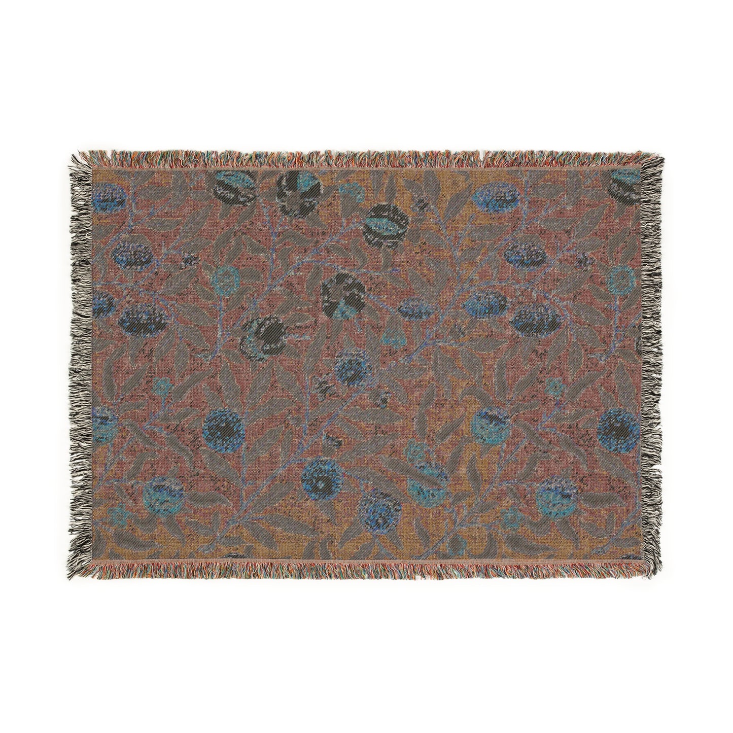 A woven cotton blanket with a floral William Morris & Co pattern in shades of blue and yellow, featuring colourful fruit motifs and a fringed edge.