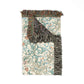 Folded blanket with fringed edges on a white background
