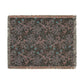 A rectangular woven throw blanket with fringe on all sides, featuring an abstract distressed pattern in dusty pink, teal blue, and light gray on a dark charcoal background.