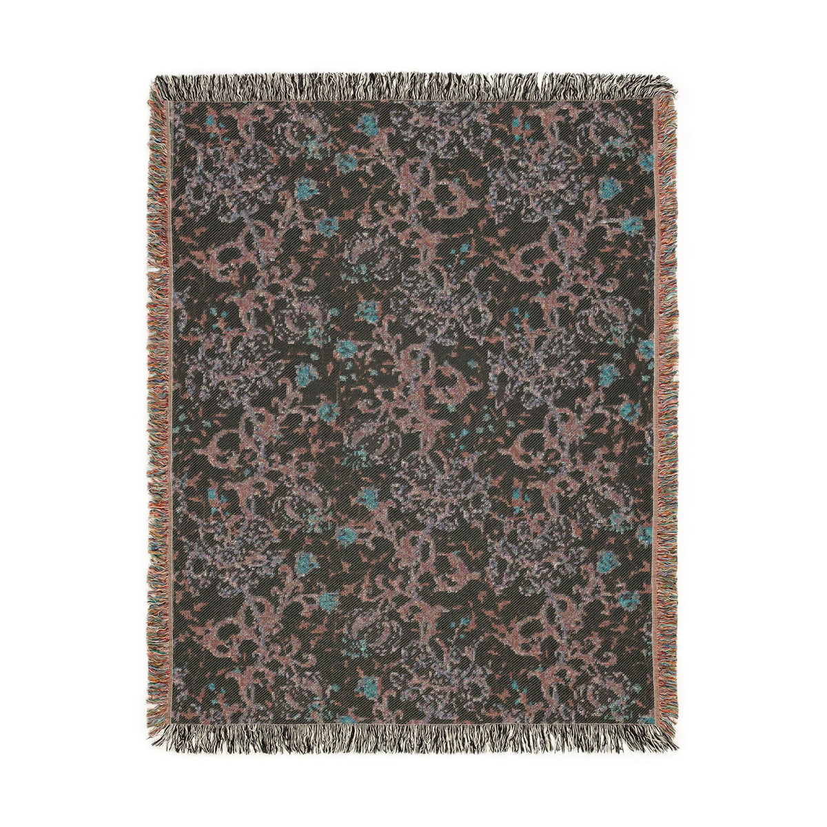A rectangular woven throw blanket with fringe on all sides, featuring an abstract floral and vine pattern in muted pink, teal, and gray on a dark charcoal background.