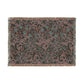 A rectangular woven throw blanket with fringe on all sides, featuring an intricate floral and scroll pattern in muted pink, teal blue, and gray on a dark charcoal background.