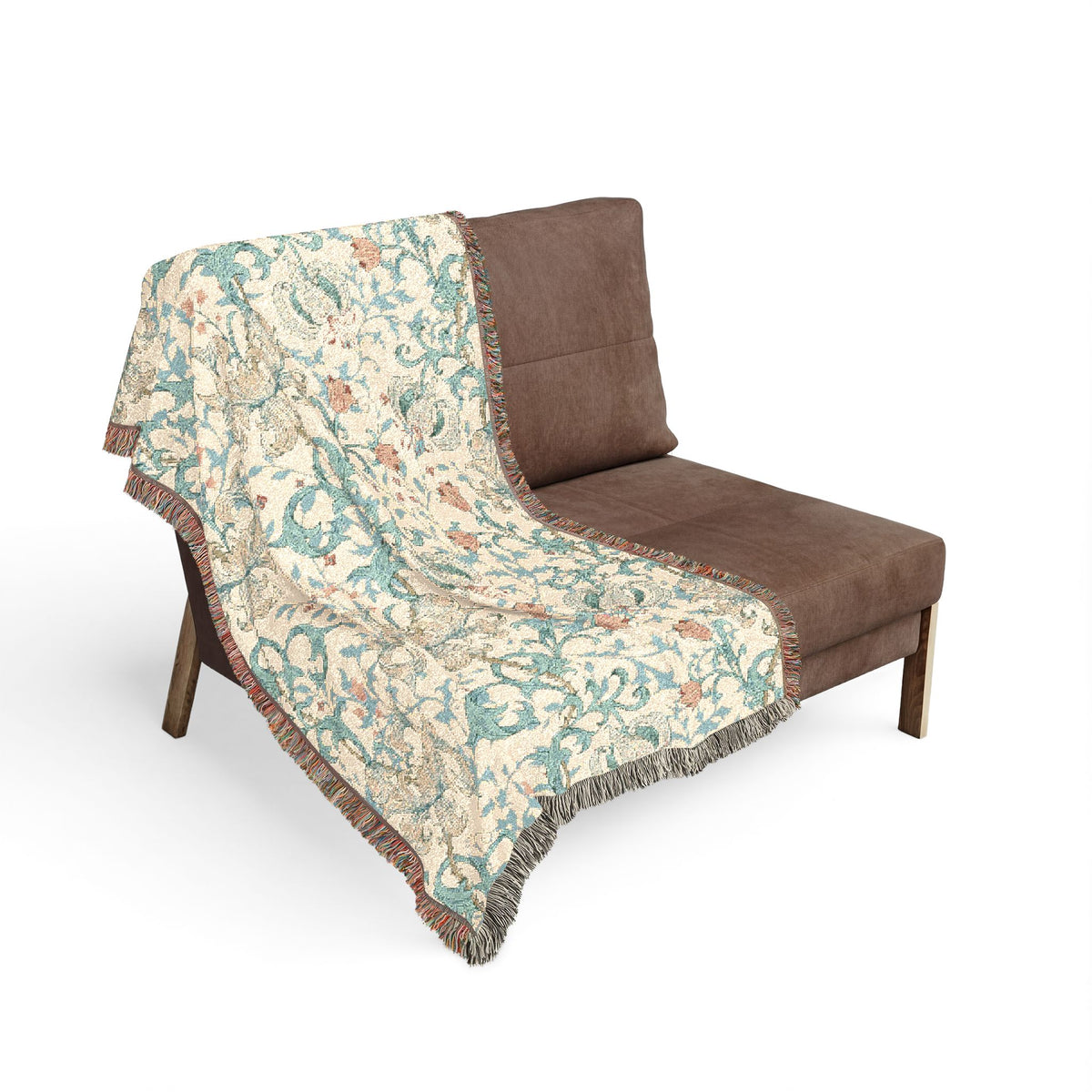 A patterned woven throw blanket with fringe is draped over a brown lounge chair against a plain white background.