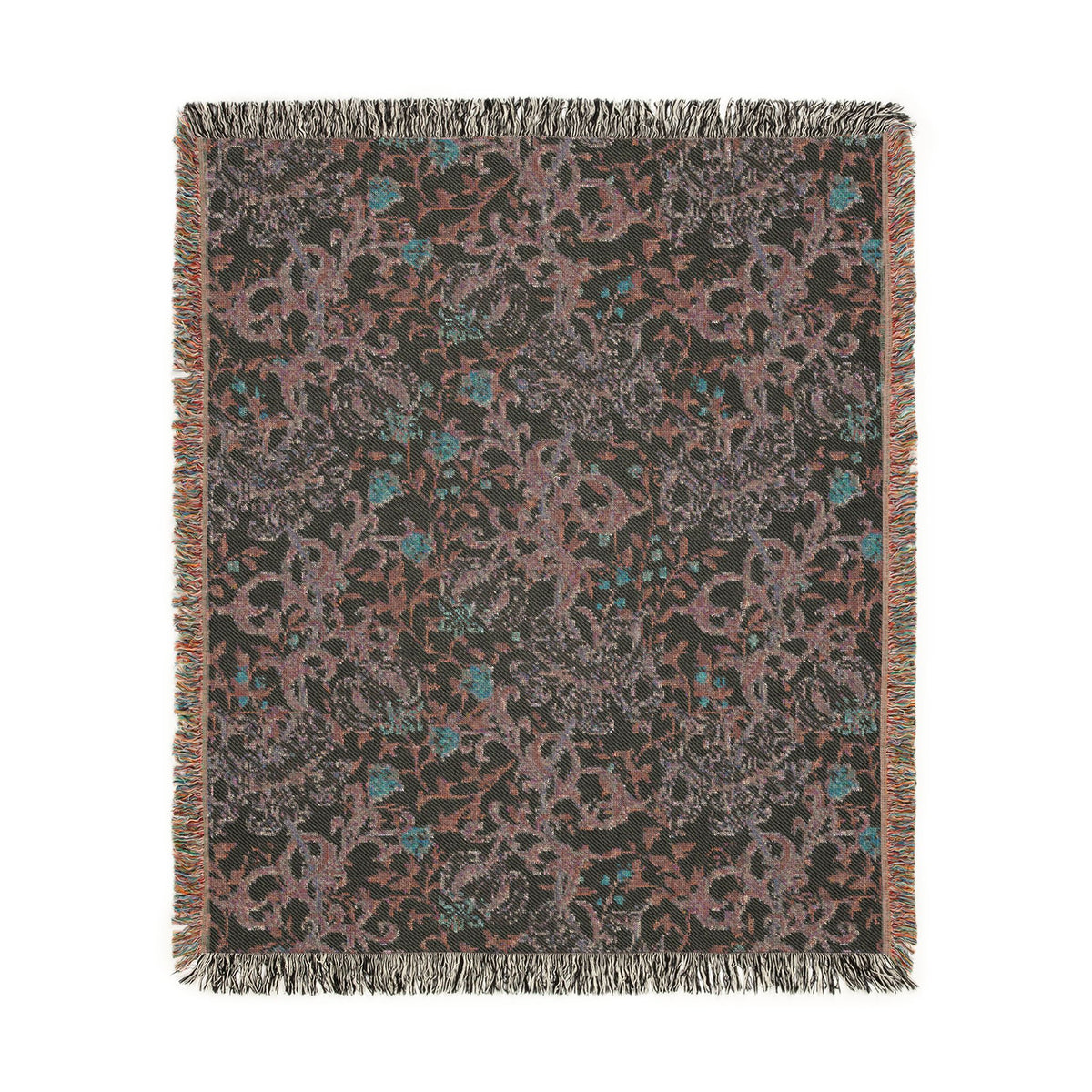 A rectangular woven throw blanket with a dark charcoal background and an intricate floral and vine pattern in dusty pink, muted teal, and light gray, finished with fringed edges.