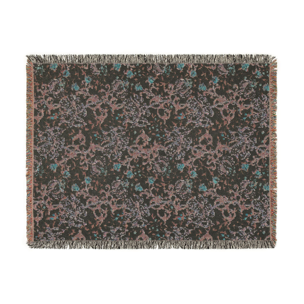 A rectangular woven throw blanket with fringed edges, featuring an abstract pattern in dusty pink, teal blue, and light gray on a dark charcoal background.