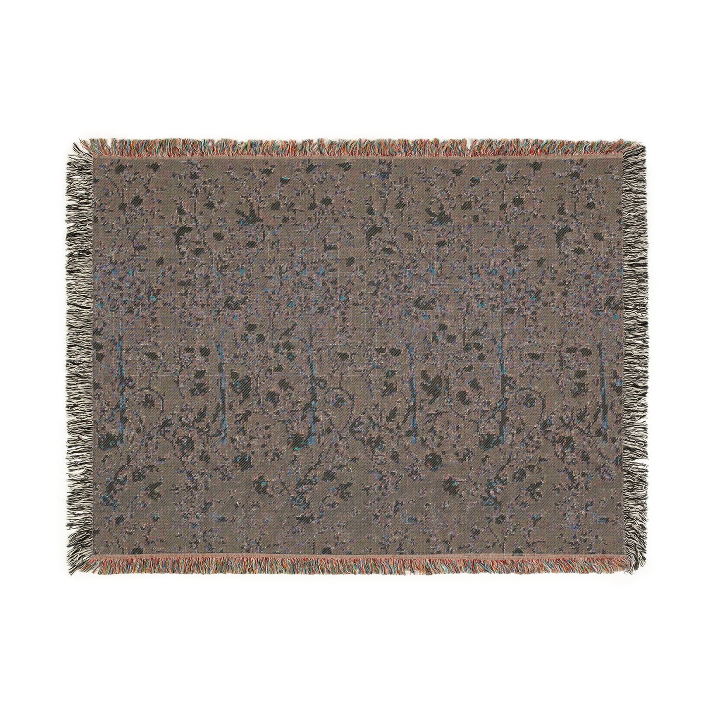 A woven cotton blanket with a geometric William Morris & Co pattern in evergreen teal colour, featuring a colourful fringed edge.