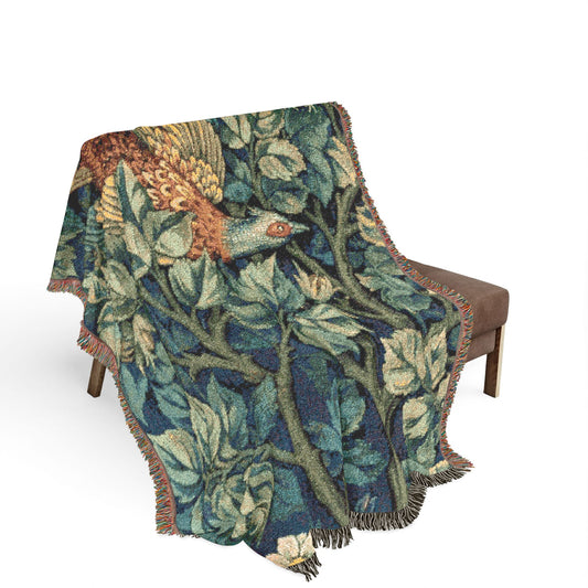Decorative blanket with nature-themed design draped over a chair on a white background