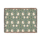 A woven cotton blanket with a green and floral pattern, featuring a colorful fringed edge.
