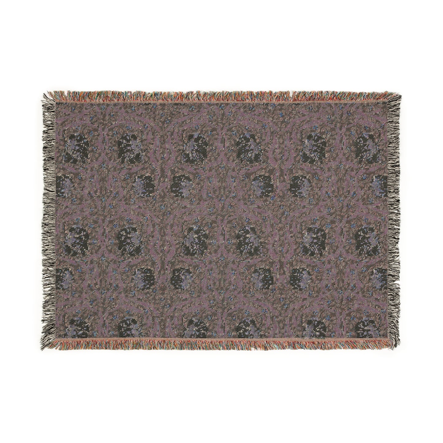 A woven cotton blanket with a green and William Morris & Co floral pattern, featuring a colourful fringed edge.