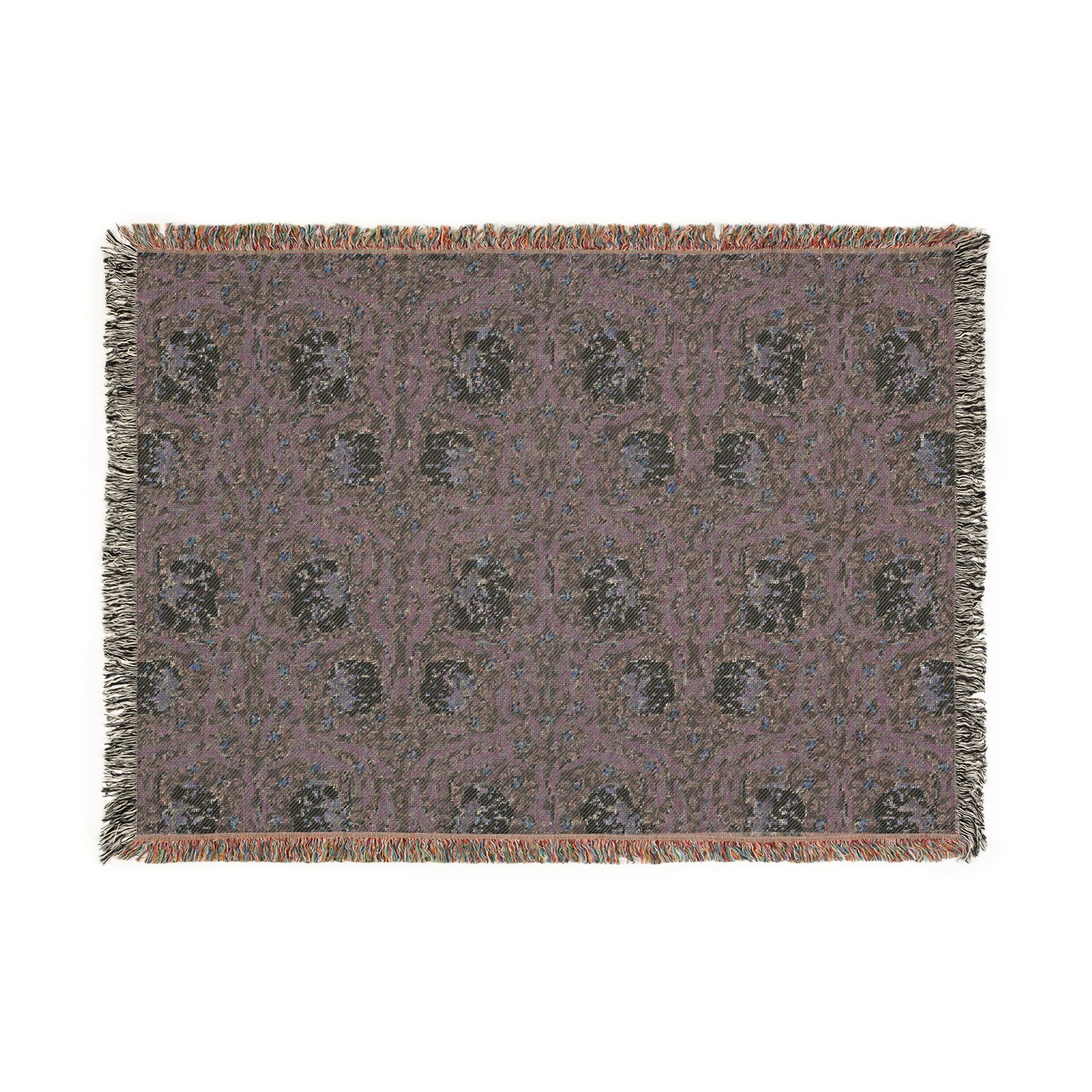 A woven cotton blanket with a green and William Morris & Co floral pattern, featuring a colourful fringed edge.