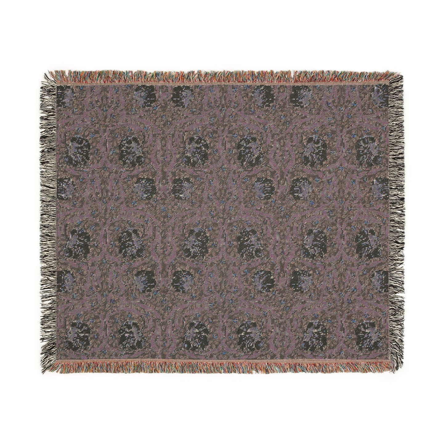 A woven cotton blanket with a green and William Morris & Co floral pattern, featuring a colourful fringed edge.