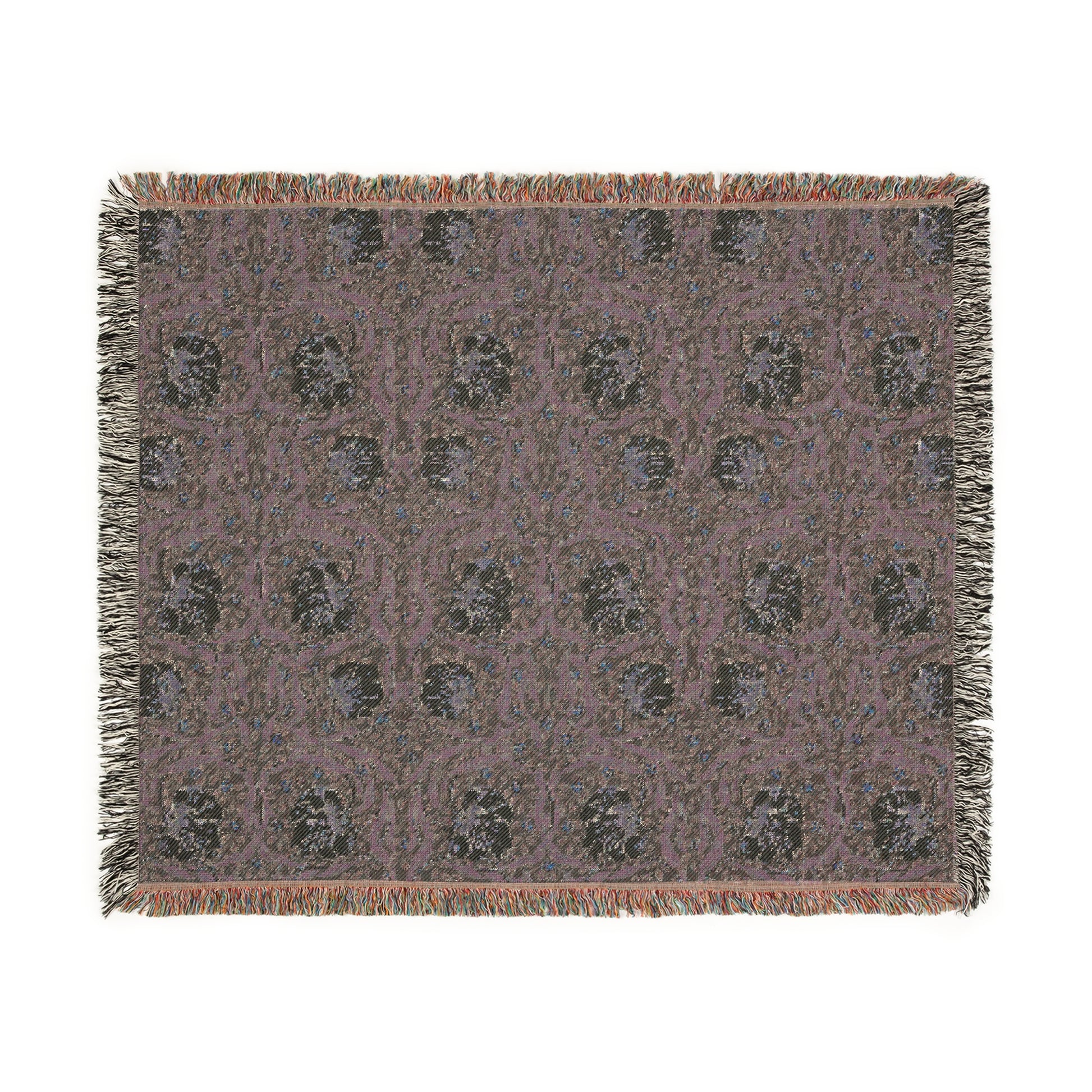 A woven cotton blanket with a green and William Morris & Co floral pattern, featuring a colourful fringed edge.