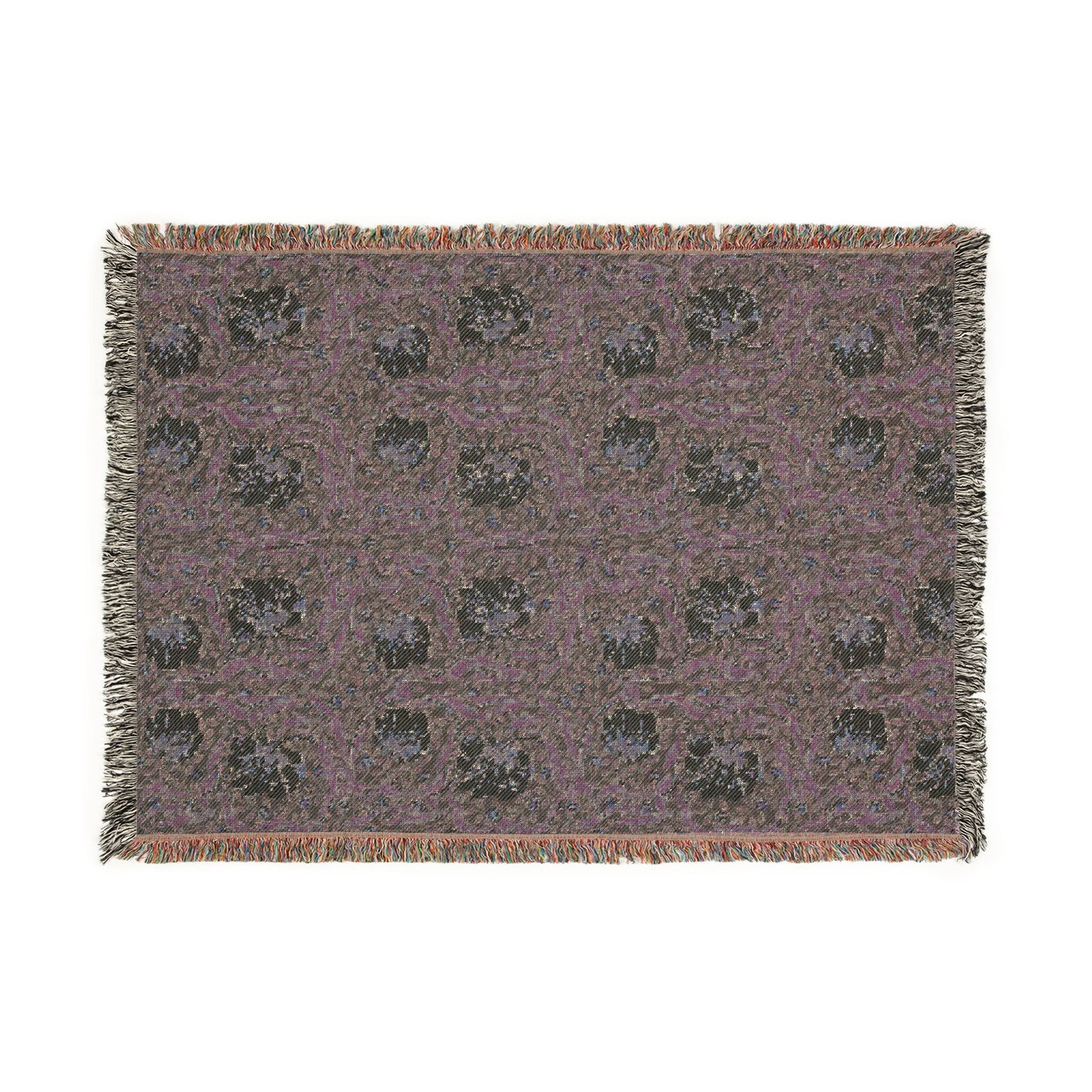 Patterned throw blanket with fringe on a white background
