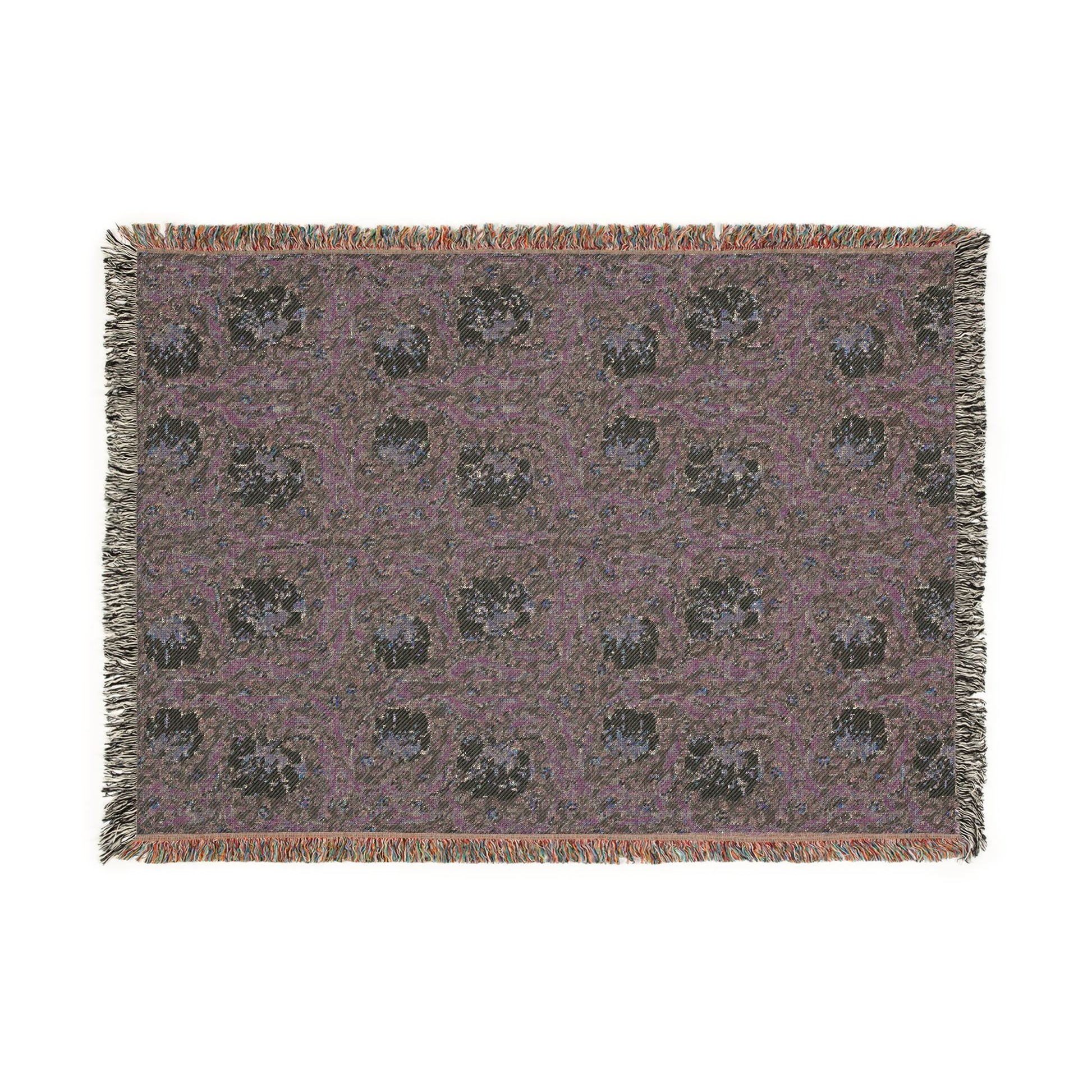 Patterned throw blanket with fringe on a white background