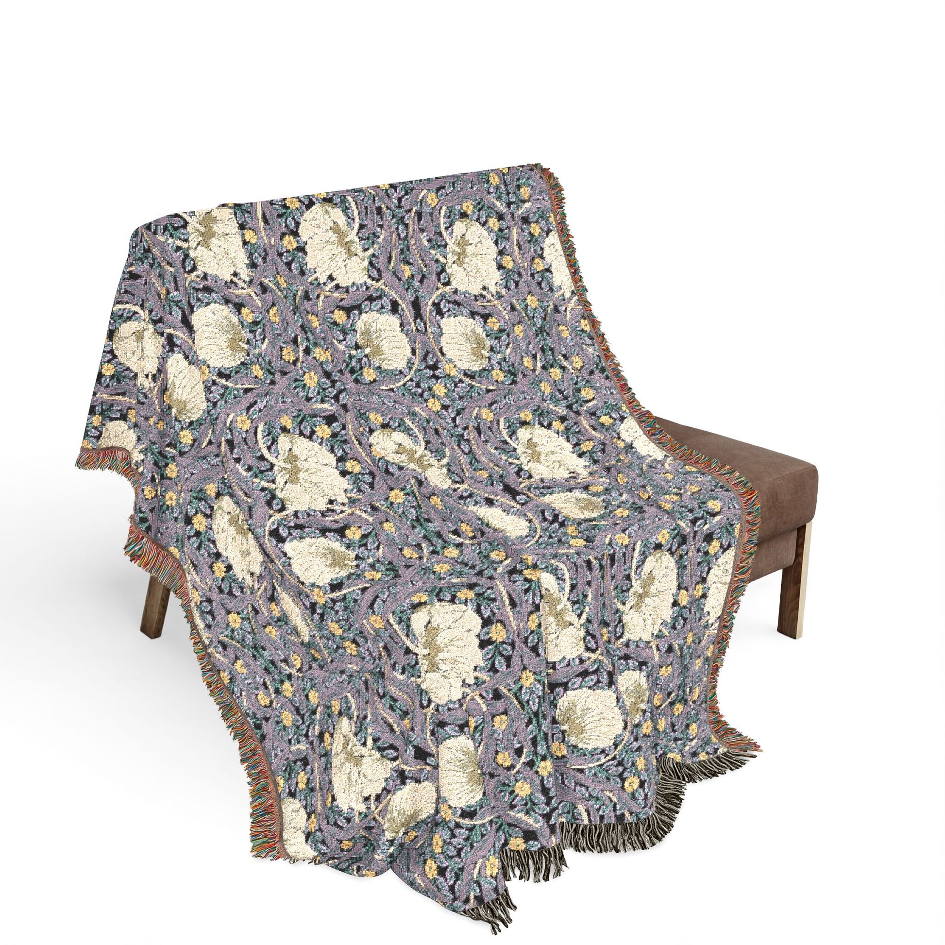 Floral patterned throw blanket draped over a chair on a white background