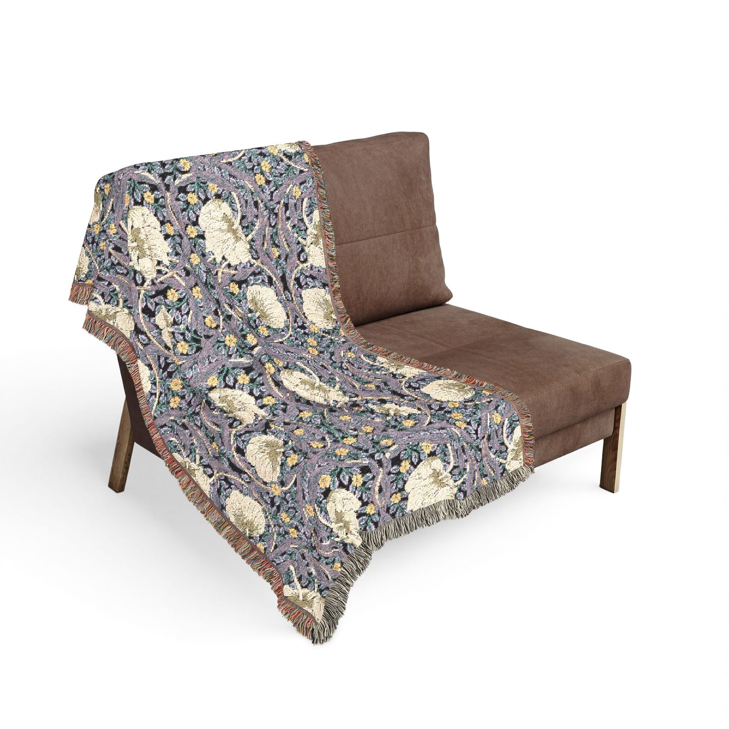 Floral patterned throw blanket draped over a brown chair on a white background