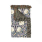 Decorative throw blanket with floral pattern and fringes on a white background