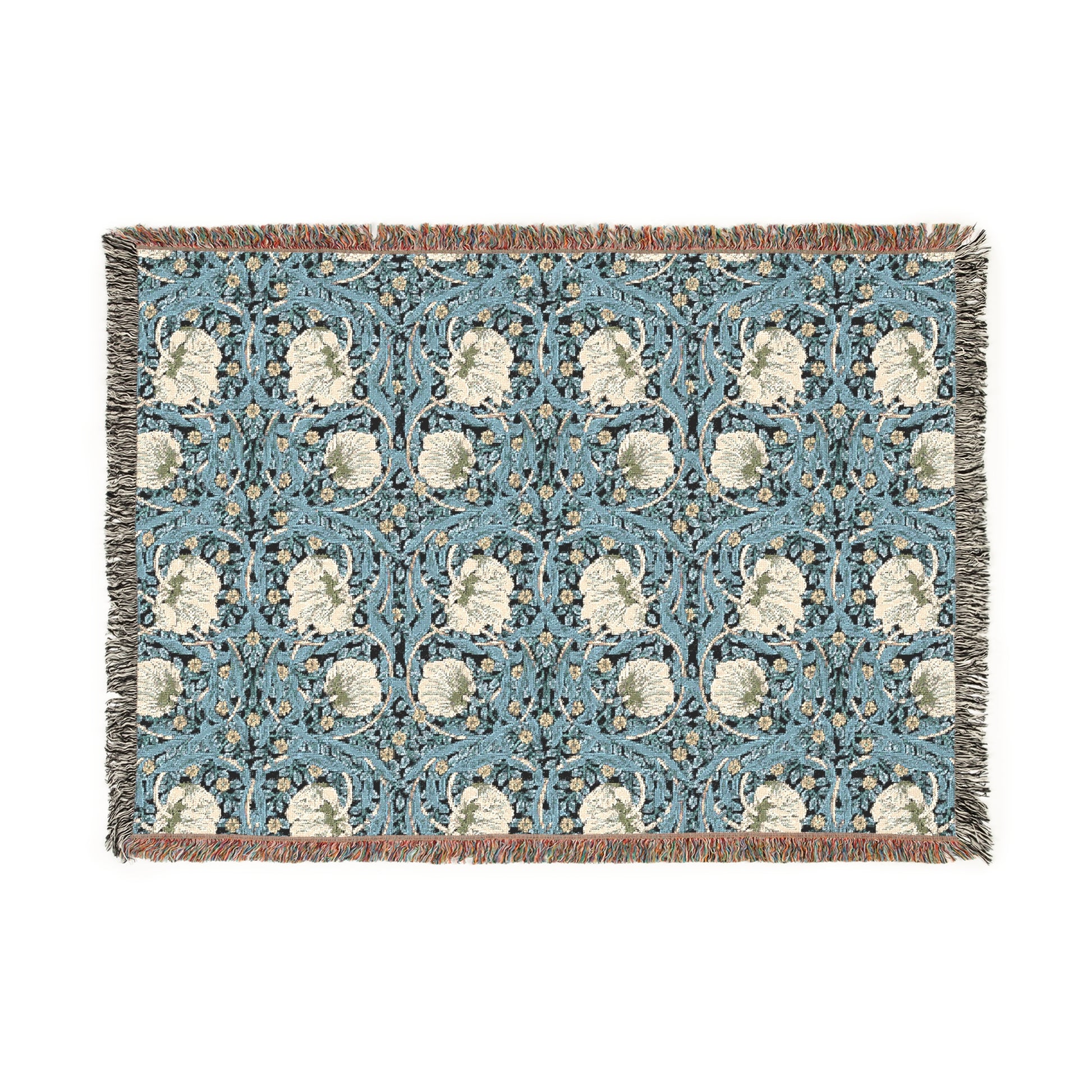 A woven cotton blanket with a geometric William Morris & Co pattern in shades of blue and beige, featuring colourful fringed edges.