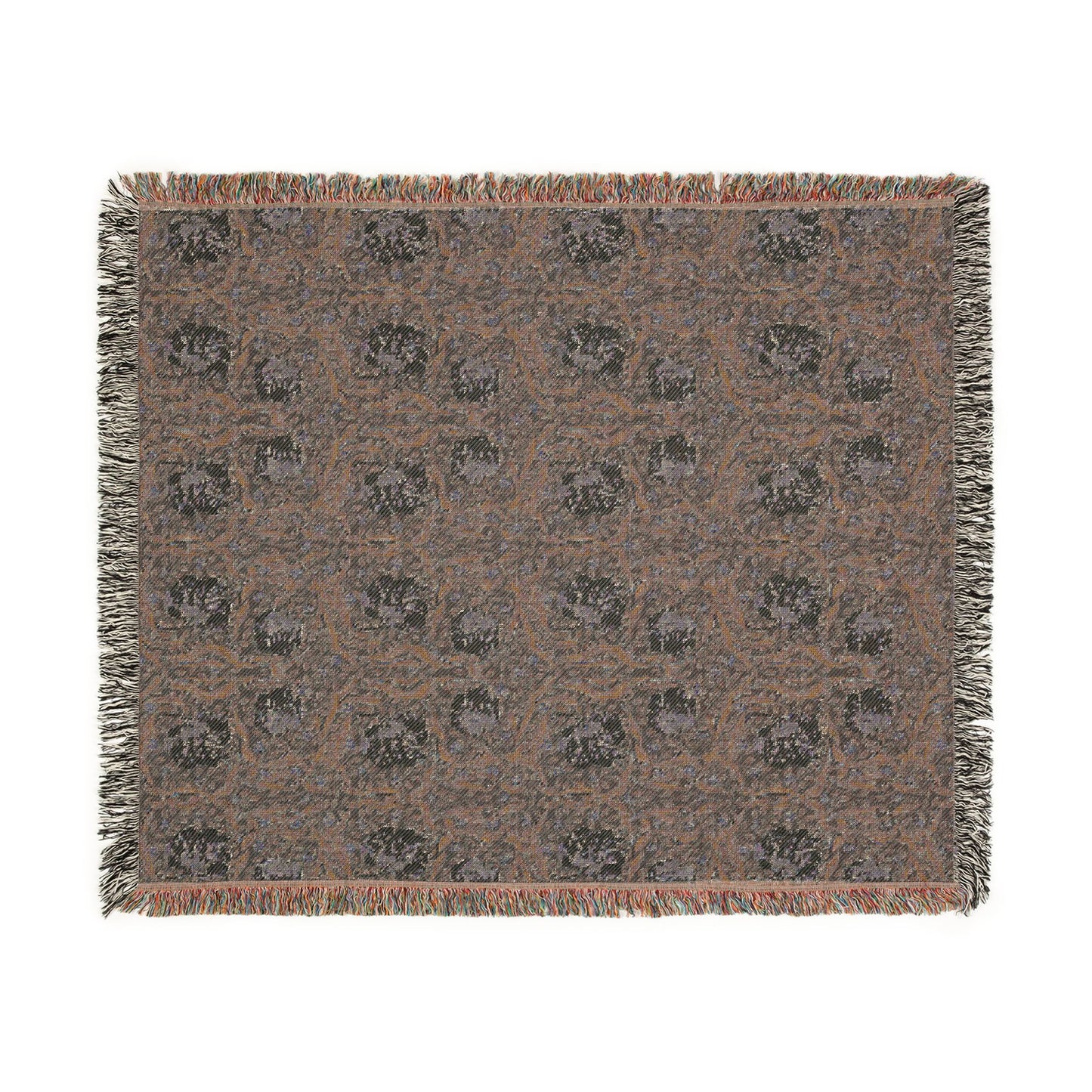 Patterned throw blanket with fringe on a white background