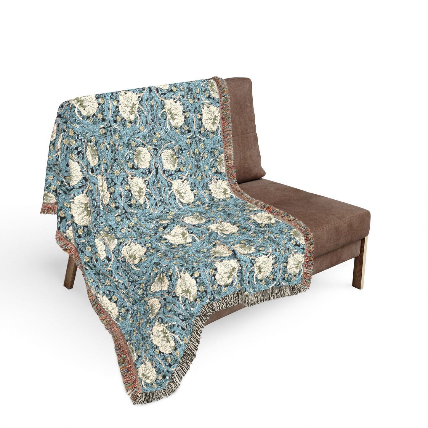 Floral patterned blanket draped over a brown chair on a white background