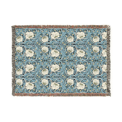 Decorative throw blanket with floral pattern on a blue background