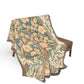 Floral patterned throw blanket draped over a chair on a white background