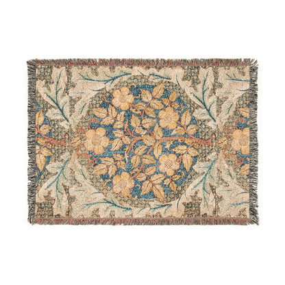 A woven cotton blanket with a floral William Morris & Co pattern in shades of blue, beige, and yellow, featuring colourful fringed edges.