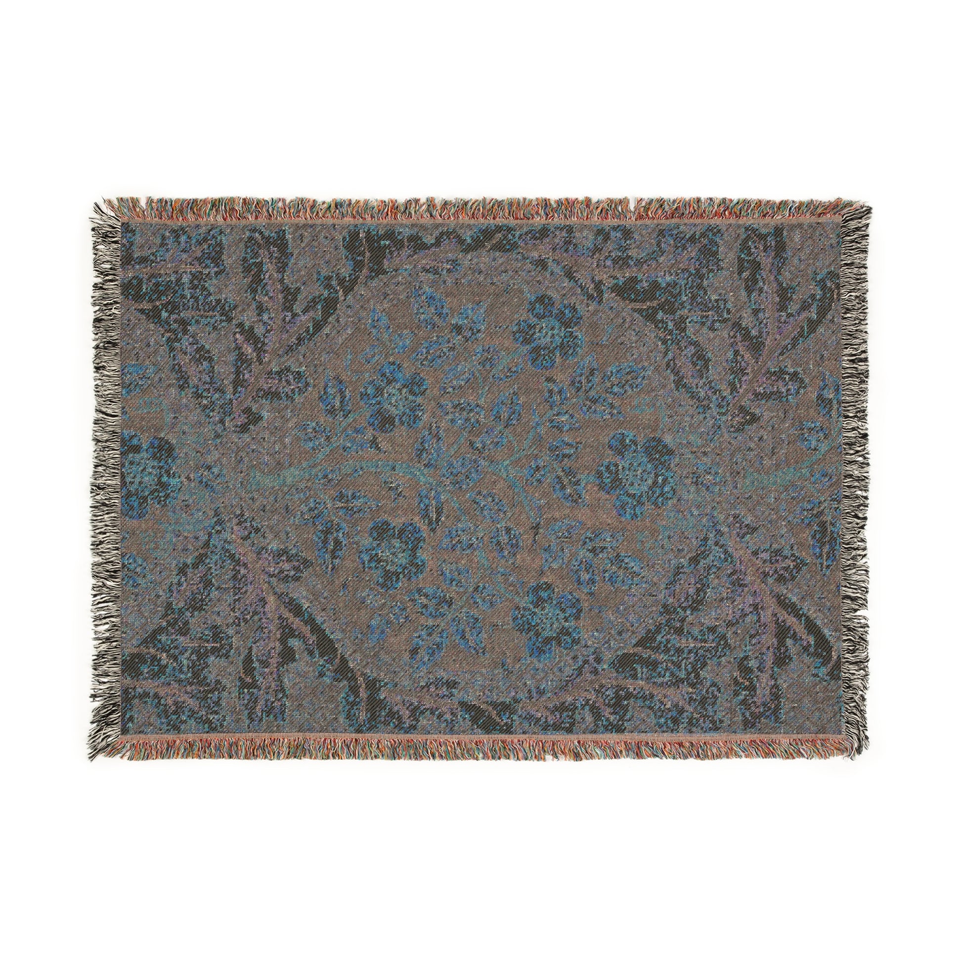 A woven cotton blanket with a floral William Morris & Co pattern in shades of blue, beige, and yellow, featuring colourful fringed edges.