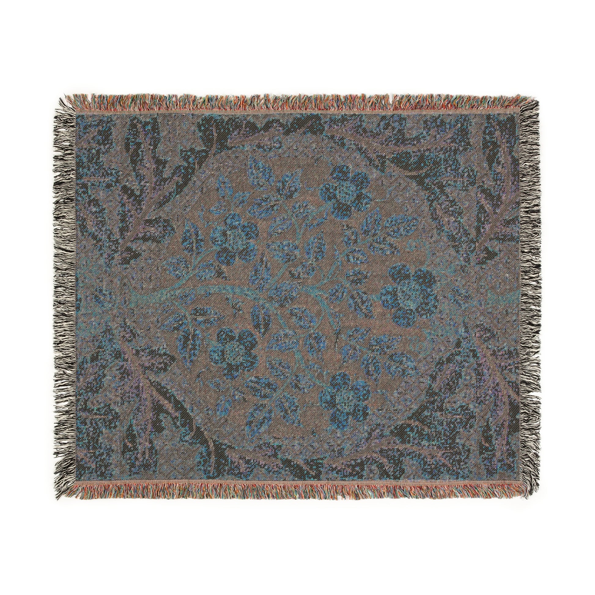 A woven cotton blanket with a floral William Morris & Co pattern in shades of blue, beige, and yellow, featuring colourful fringed edges.