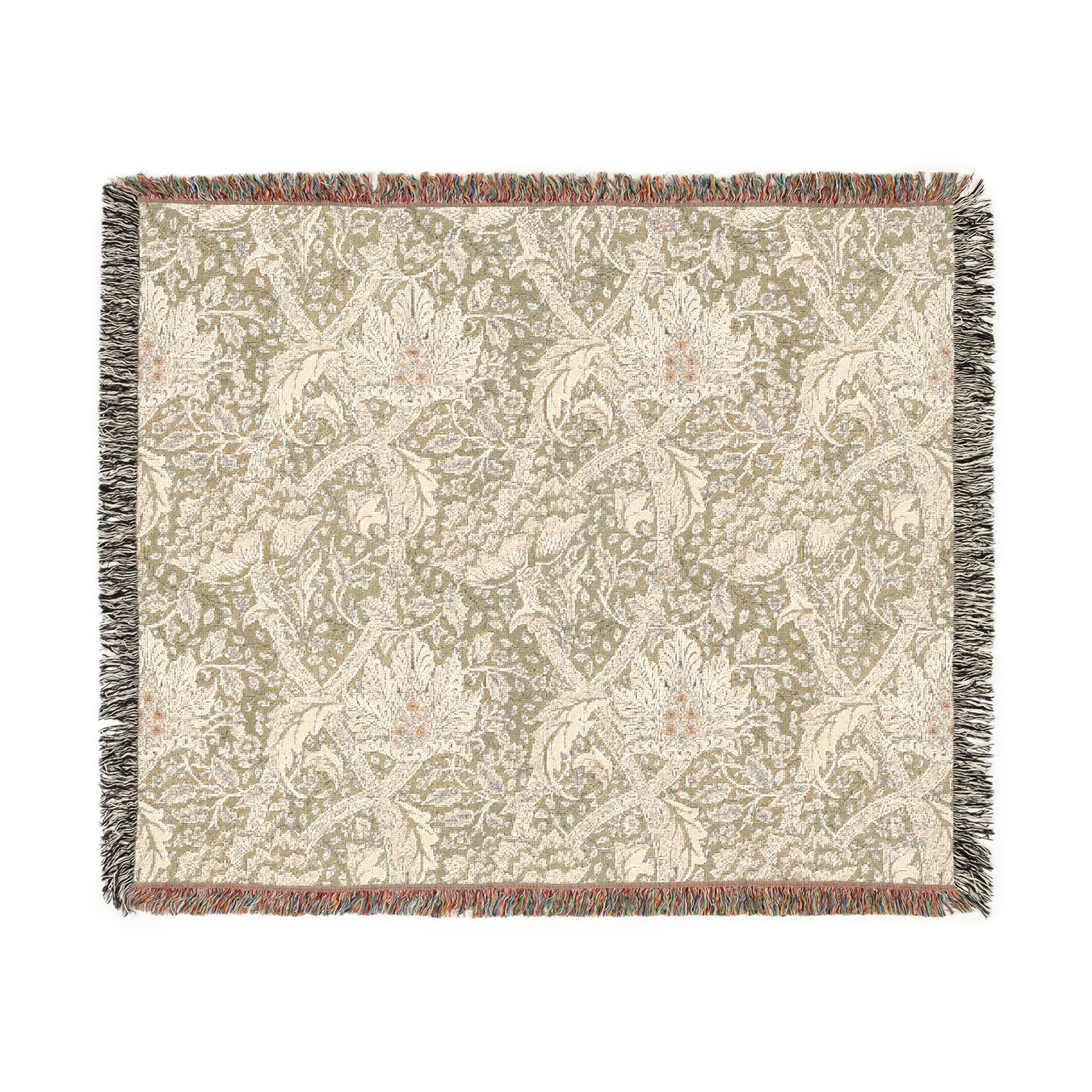 A woven cotton blanket with a floral pattern in shades of green and beige, with a colorful fringed edge.