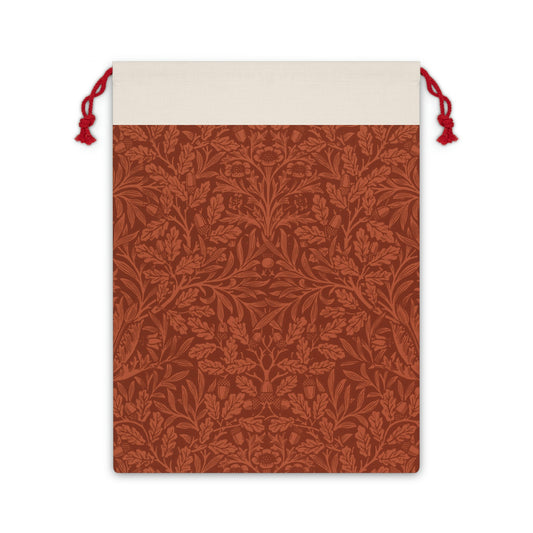 A rectangular Christmas gift bag with a vintage design, featuring an embossed acorn and oak leaf pattern on a beige background, finished with a red drawstring at the top.